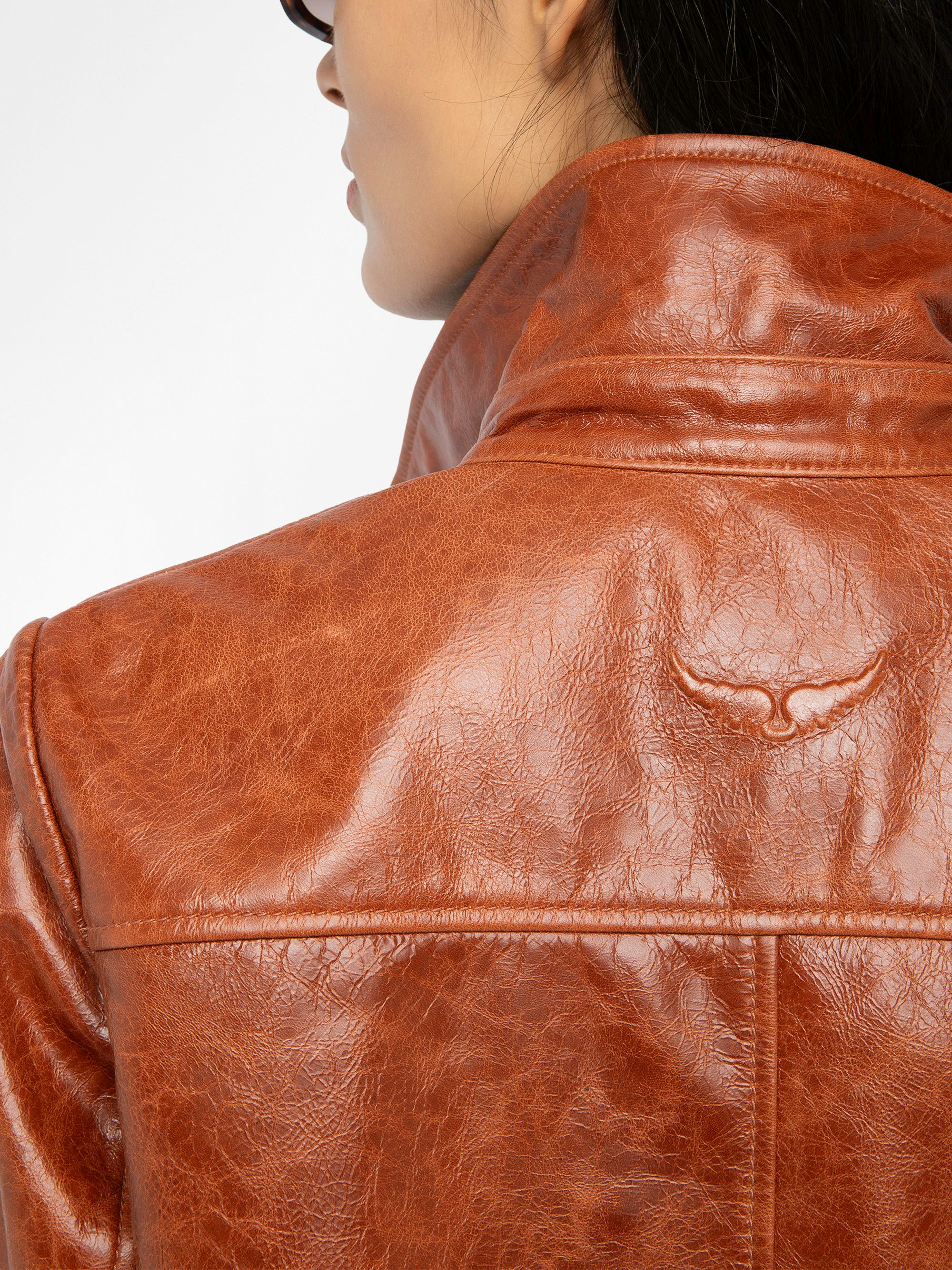 Lienna Leather Jacket - Glossy leather jacket with multiple pockets featuring zip closure and embossed wings on the back.